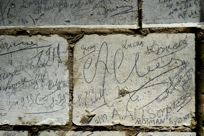 Regroupement de noms de soldats australiens de la Grande Guerre retrouvées dans la grotte souterraine de Naours (Somme), 2016.  On note en bas à droite du cliché l’inscription laissée par Allan Allsop le 2 janvier 1917. C’est grâce au journal de marche de ce soldat que l’on apprend qu’il est venu avec 10 de ses camarades ce jour-là visiter les « cavernes de Naours ».