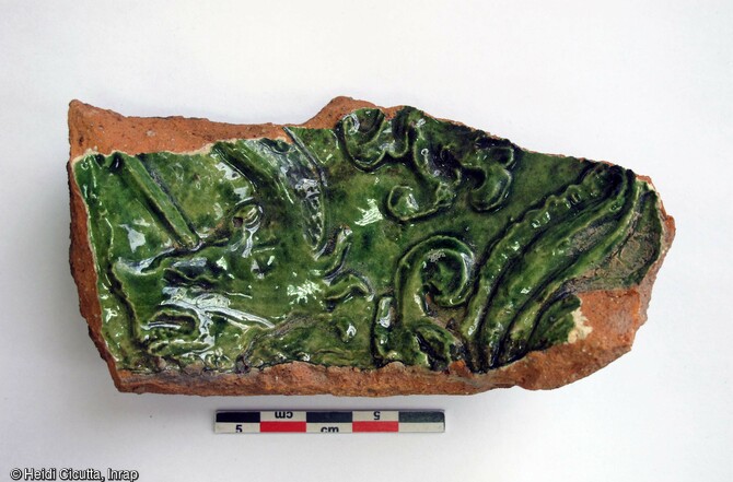 Fragment de pot à cuire en terre cuite à pâte rouge semi-fine, non engobé, découvert dans une fosse du site et attribué au bas Moyen Âge (XVe s.).