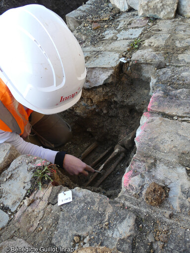 Découverte d'un membre inférieur (tibia/fibula) dans une sépulture au sud du chevet de l'église Saint-Georges au cœur du Château de Caen (Calvados). Les premiers terrassements ont livré des sépultures orientées est-ouest, provenant du cimetière paroissial qui existait autour de l'édifice jusqu'à la fin du XVIIIe siècle. 