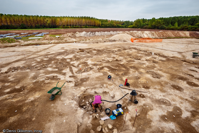 Une équipe d'archéologues de l'Inrap a étudié un site néolithique à Pont-sur-Seine (Aube) sur une surface de 4 hectares en 2009. Le village mis au jour est exceptionnel par la densité de l'occupation, la monumentalité des bâtiments et le caractère inédit de certaines architectures.  Ici, la fouille en cours de la fosse, probablement rituelle, située au centre du bâtiment de 900 m2. Les traces noires au sol et les pierres correspondent à des éléments participant à l'architecture du bâtiment (fosses et trous de poteaux).