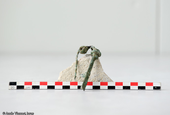 Fibule, avec ressort, en queue de paon, retrouvée dans un fossé à proximité d’un monument funéraire découvert dans une nécropole datée du tout début de l'époque romaine. Ce type d’épingle est courant à l’époque gallo-romaine pour accrocher les vêtements.