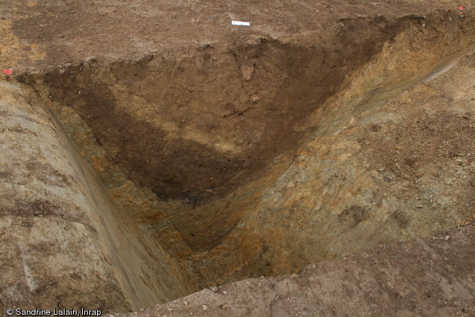 Coupe réalisée dans un des fossés délimitant l'enclos dans lequel s'est développée la ferme médiévale, VIe-IXe s., Caudan (Morbihan), 2013. Ces fossés atteignent une profondeur et une largeur d'environ 2 m.