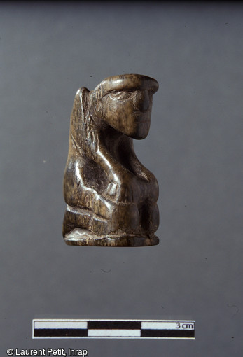 Pion d'un jeu d'échecs en os, seconde moitié du XIe s., Pineuilh (Gironde), 2003. Comptant parmi les plus anciens exemplaires connus, cette pièce figurative témoigne d'un statut social élevé.