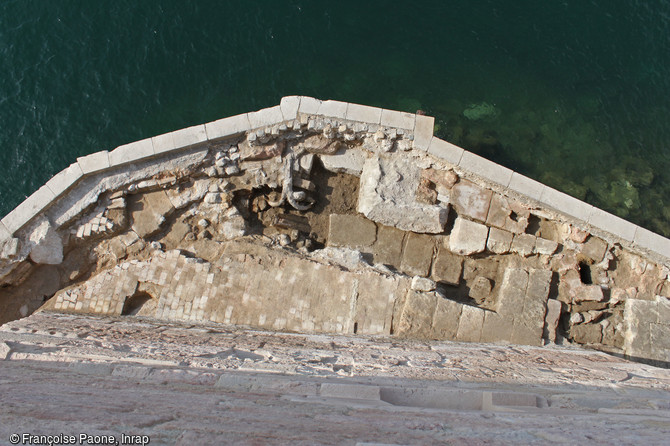   Vestiges du ravelin situé au pied de la tour du Roi René au fort Saint-Jean à Marseille.On peut observer une succession de dallages et de sols en terre cuite mis en place entre le XVe et le XIXe s. ainsi qu'une ancre destinée à fixer la chaîne du port.    Photo publiée dans l'ouvrage Quand les archéologues redécouvrent Marseille, M. Bouiron, P. Mellinand.    